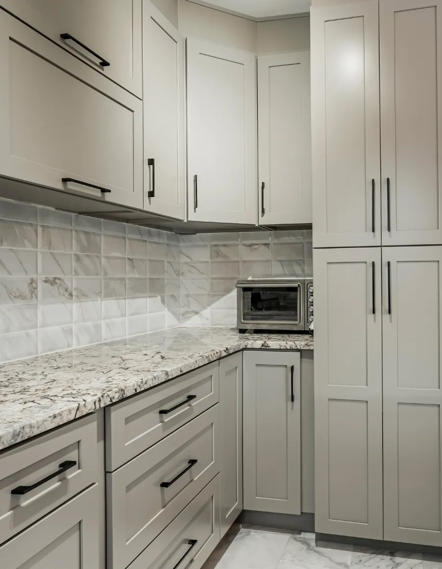Grey Shaker drawers, wall cabinets and a tall pantry with black pulls